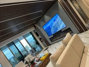 Black slatted ceiling with mounted TV and contemporary living room interior