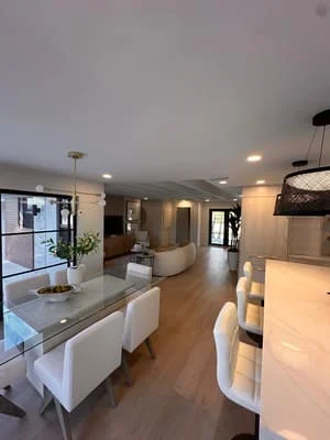 Open kitchen with white cabinetry, quartz counters, hardwood floors, and recessed lighting